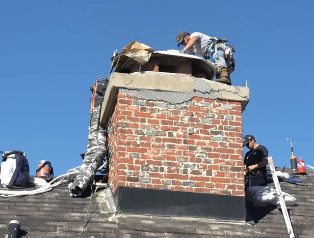 Beachwood Chimney Sweep installing a custom chimney crown in Beachwood, OH