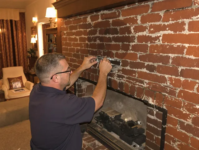Beachwood Chimney Sweep expert fixing a fireplace in Beachwood, OH